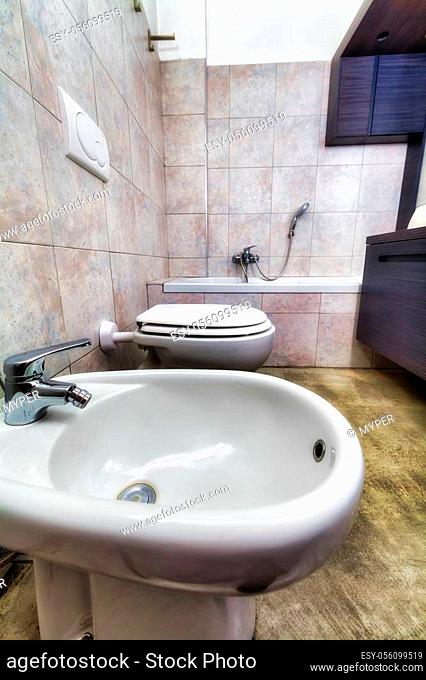 Grey modern hdr bathroom with toilette, bidet, washbasin and tub