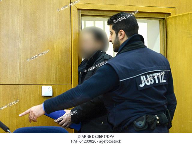 Defendant Hamayon S. (L) arrives in a courtroom of the regional court in Frankfurt/Main, Germany, 09 December 2014. The 48-year old man is accused of double...