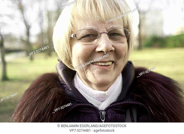 smiling senior woman outdoors in park, in Cottbus, Brandenburg, Germany
