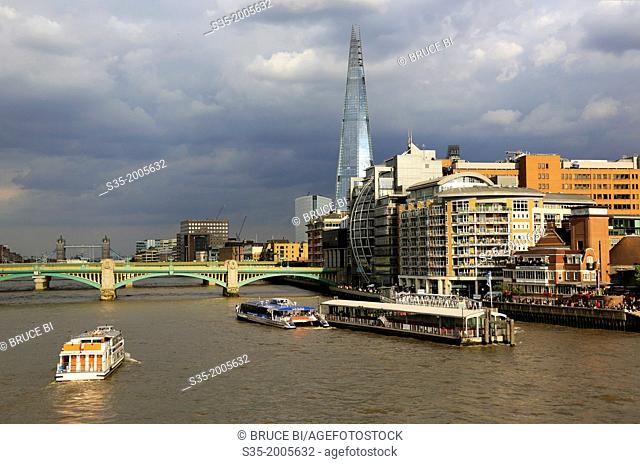 A tour boat in River Thames with the Shard the tallest building in the European Union in the background, London, England, UK