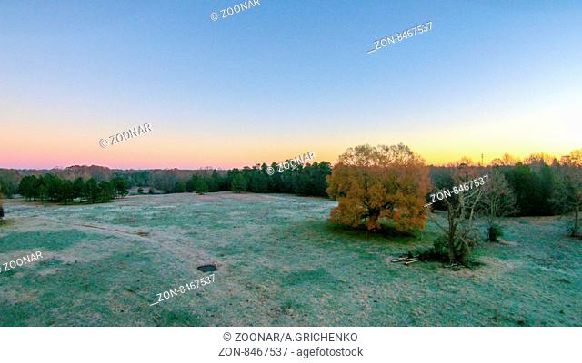 morning sunrise over frost covered farm land