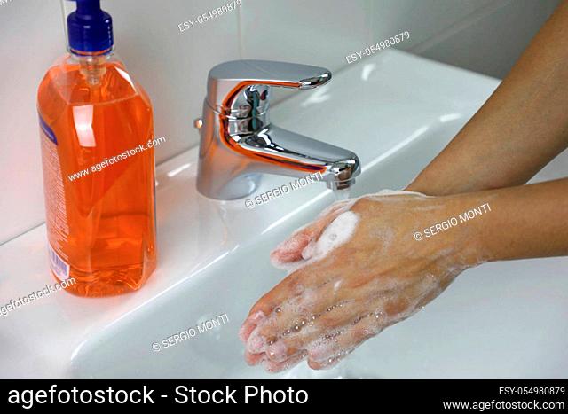 COVID-19 Hygiene concept. Washing hands with soap under the faucet with water against Novel coronavirus (2019-nCoV). Antiseptic, Hygiene and Healthcare concept