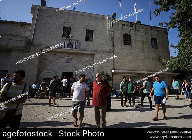 20 October 2023, Palestinian Territories, Gaza City: People inspect damages after an Israeli airstrike. One of the buildings belonging to the Greek Orthodox...