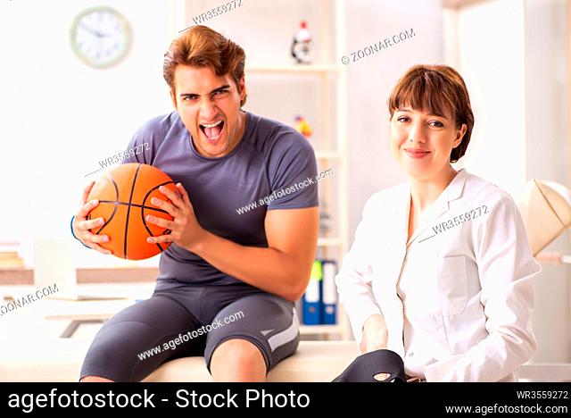 Handsome basketball player visiting female doctor traumatologist