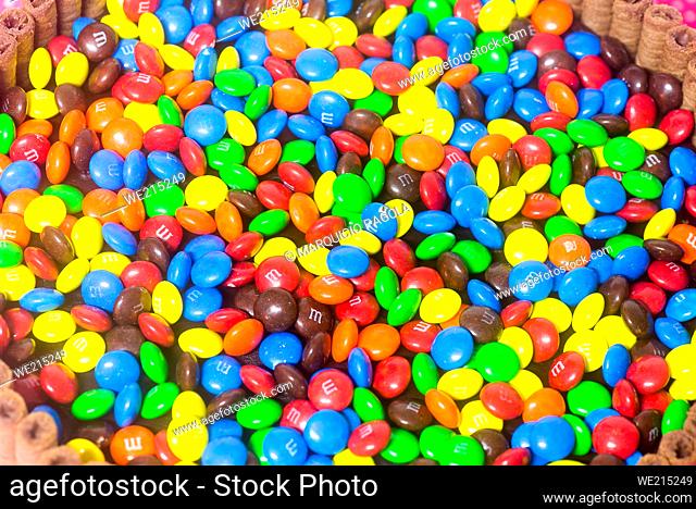 inner view of a birthday cake filled with colorful m&m and other candies