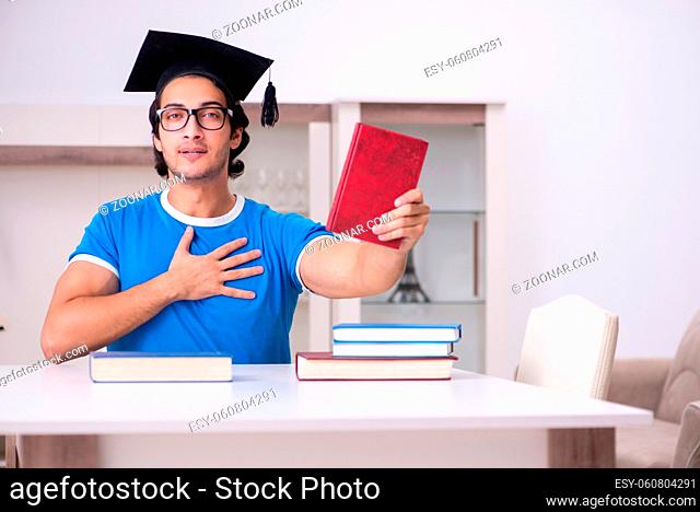 Young handsome student studying at home