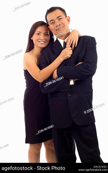 Happy Asian couple standing together isolated over white background