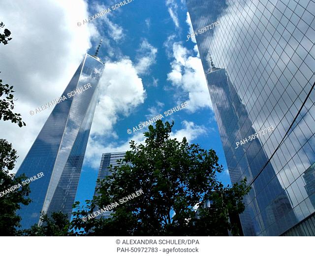 Clouds mirror on the facade of One World Trade Center (WTC 1) (L) office highrise, previously known as the Freedom Tower, in New York City, USA, 20 June 2014