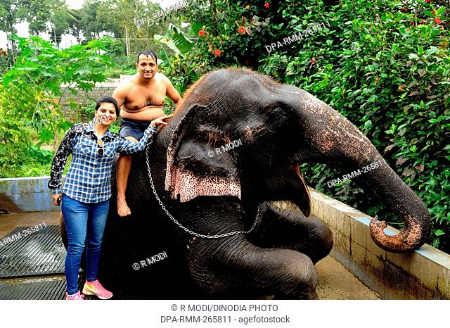 couple posing near elephant, Thekkady, Kerala, India, Asia, MR#801B, MR#802B
