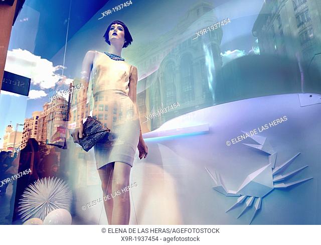 Mannequin and reflections at a window shop in Gran Via avenue. Madrid. Spain