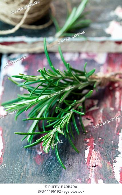 Fresh rosemary on a colorful, wooden surface
