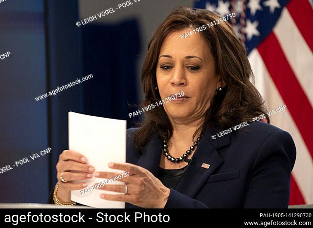 United States Vice President Kamala Harris organizes paperwork after meeting with community leaders to discuss COVID-19 public education efforts in the South...
