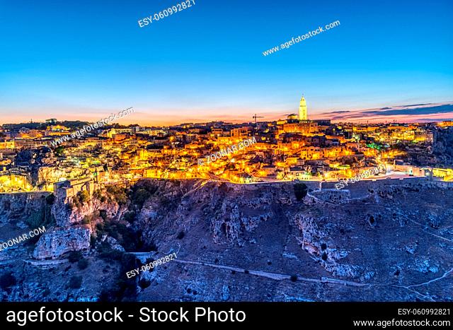 Blick auf die schöne Altstadt von Matera und die Schlucht des Flusses Gravina nach Sonnenuntergang