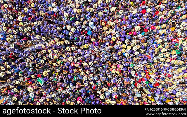 HANDOUT - 16 August 2023, Brazil, Brasilia: In this picture provided by the Brazilian President's Office, numerous women in purple take part in the ""March of...