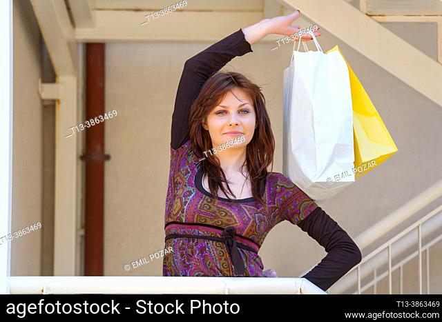 Teen girl with shopping-bags in hand