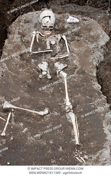 Archaelogists inspects a grave with a skeleton with an iron rod penetrated the heart body area, dated back in the Middle Ages in the ancient Thracian temple of...