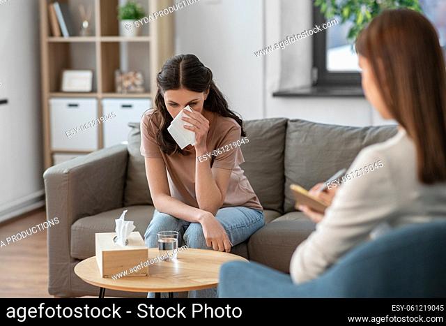 crying woman and psychologist at psychotherapy