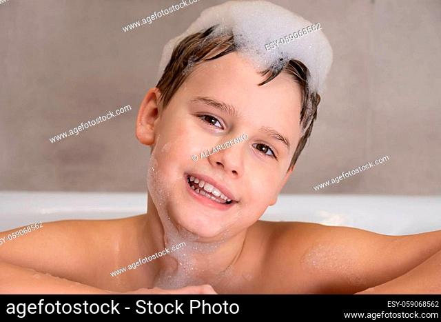 Portrait of Happy boy in bathroom Child bathes with lather on his head