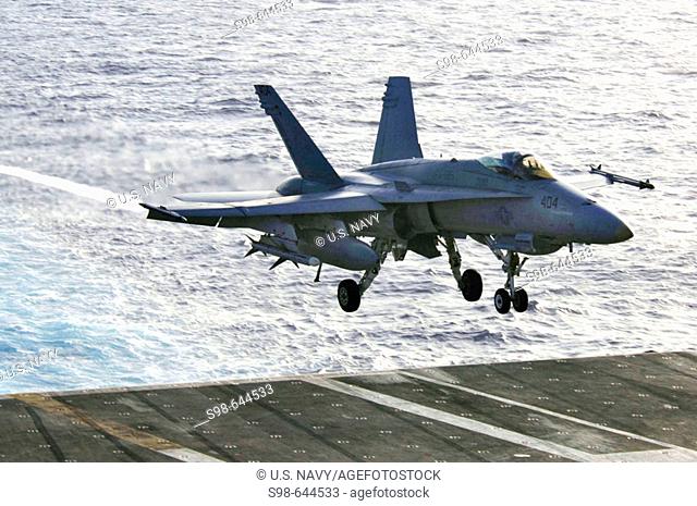 PACIFIC OCEAN (June 23, 2006) - An F/A-18C Hornet of Strike Fighter Squadron (VFA) 195, t he 'Dambusters, ' prepares to land on the flight deck of USS Kitty...