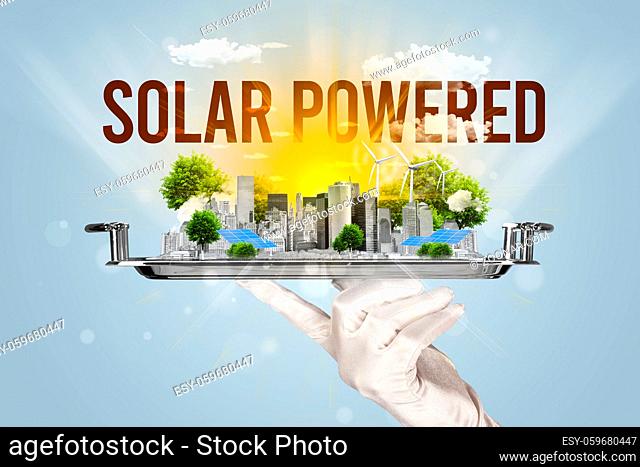 Waiter serving eco city with SOLAR POWERED inscription, renewabke energy concept