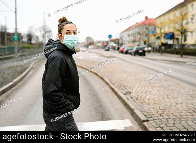 Woman wearing face mask looking away