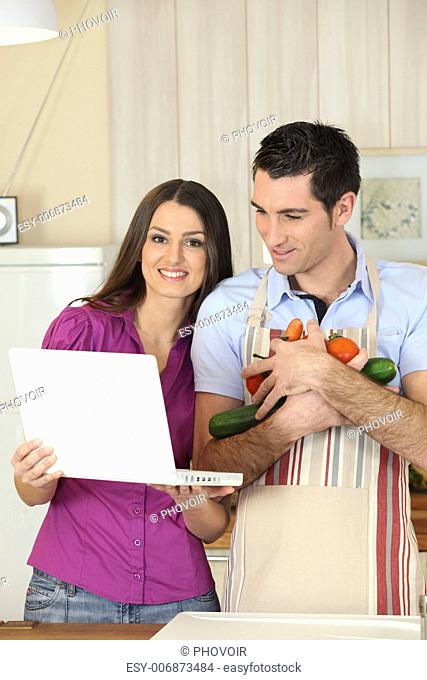 Couple looking-up recipe on laptop