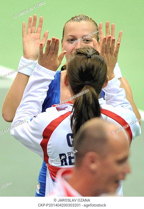 Czech Republic's Petra Kvitova and Lucie Safarova celebrate after defeating Italy's Roberta Vinci in the Fed Cup semifinal tennis match in Ostrava
