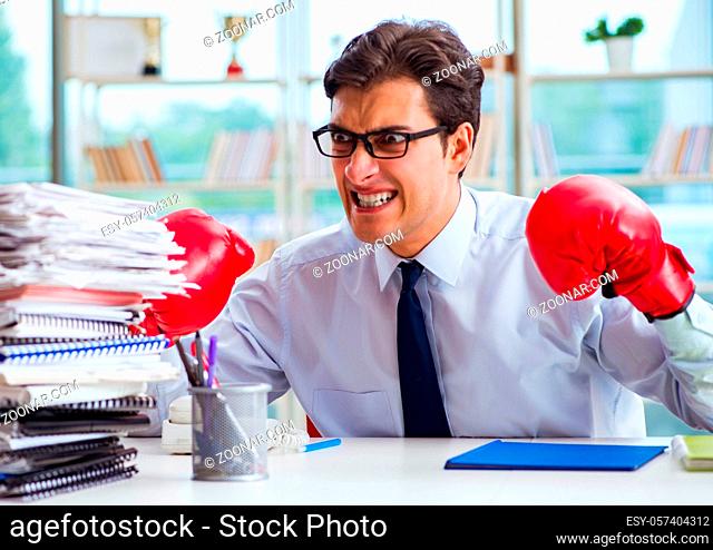 The businessman with boxing gloves in the office