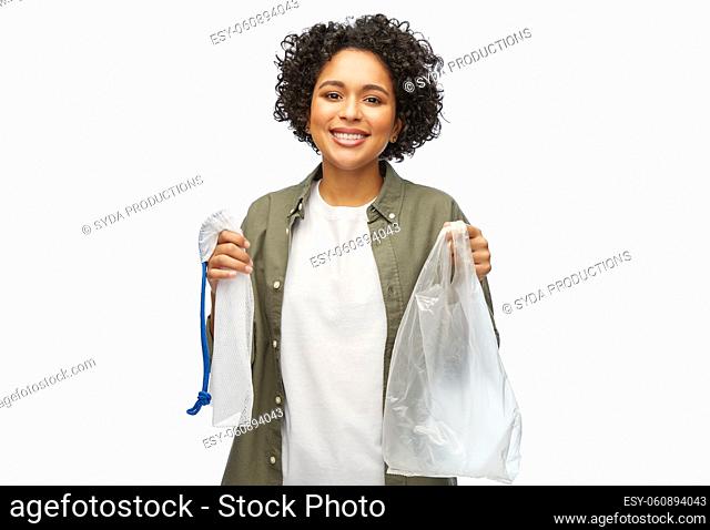 happy woman with plastic and reusable string bag