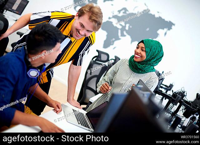 Multiethnic startup business team Arabian woman wearing a hijab on meeting in modern open plan office interior brainstorming