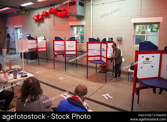 A woman casts her vote at the Alexandria Fire Department Station No. 4, on Election Day in Alexandria, Va., Tuesday, November 3, 2020
