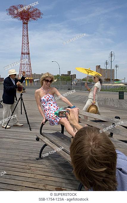 Young man and a senior man photographing a young woman and a senior woman, Parachute Drop, Coney Island, New York City, New York, USA