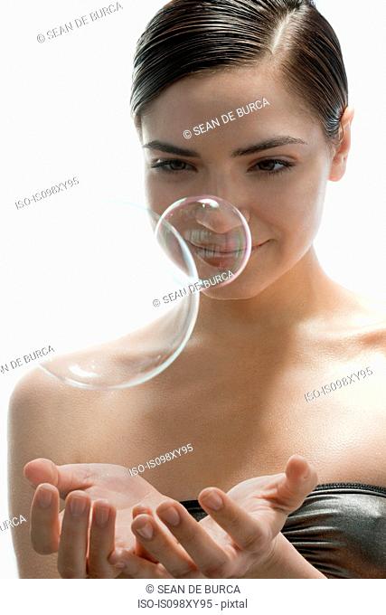 Portrait of young woman with two bubbles
