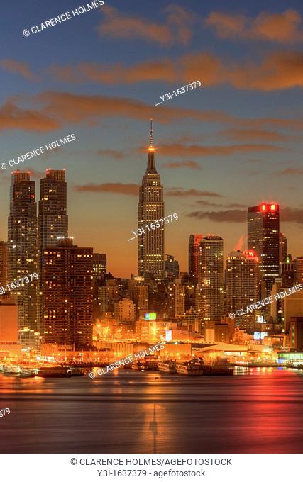 The Empire State Building in New York City during morning twilight as viewed over the Hudson River looking east from New Jersey