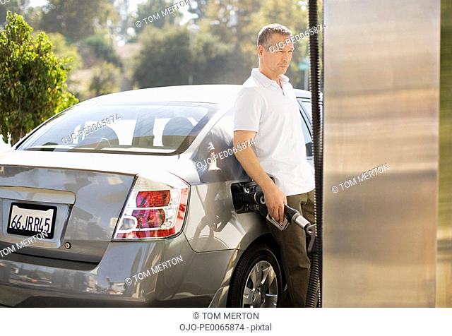 Man filling car at gas station