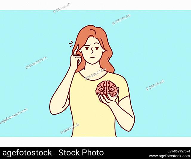 Young woman hold brain pint at head