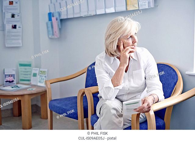 Mature female patient in hospital waiting room