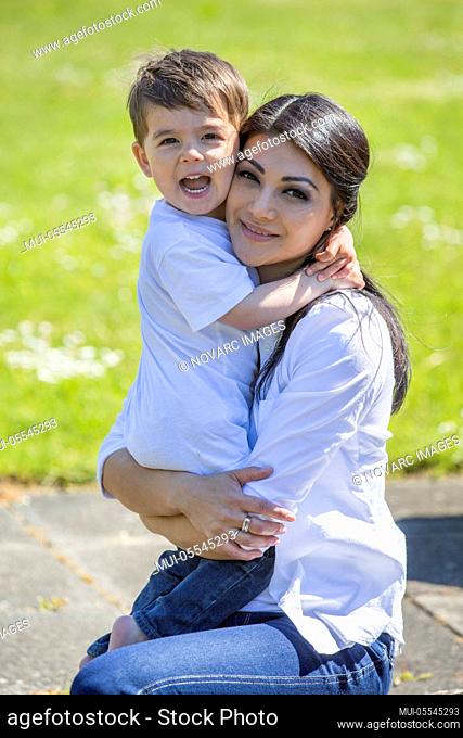 Mother hugs her little son