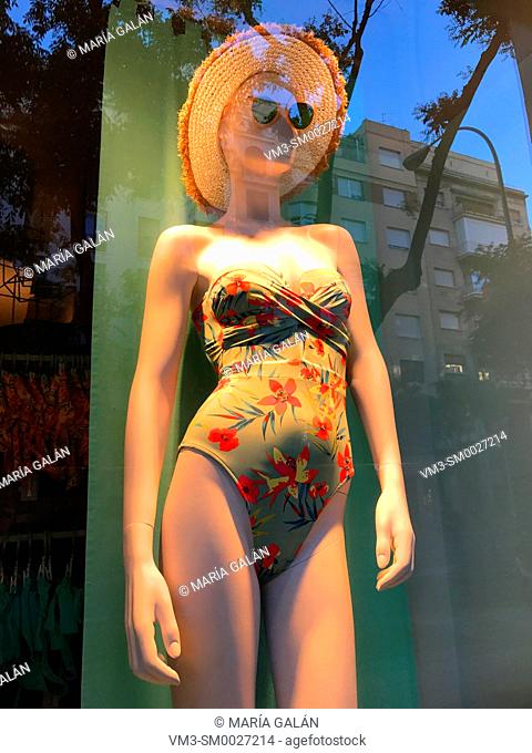 Mannequin in shop window wearing swimsuit, hat and sunglasses. Madrid, Spain