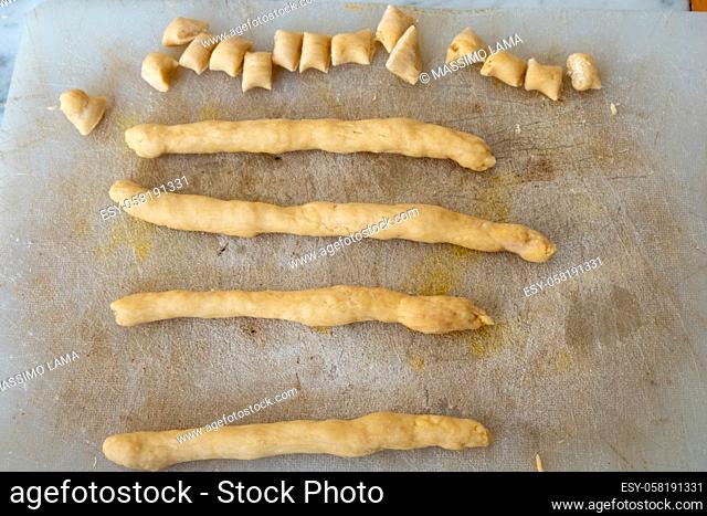 preparation of struffoli 1. Roll out the dough made from eggs, flour, Marsala wine and sugar, in the shape of a stick and cut into chunks