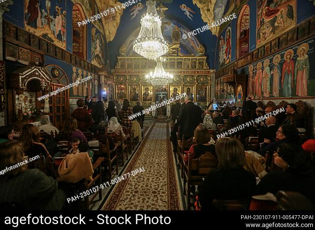 07 January 2023, Palestinian Territories, Gaza City: Palestinian Greek Orthodox Christians attend a Christmas Eve Mass led by Greek Orthodox Archbishop Alexios...