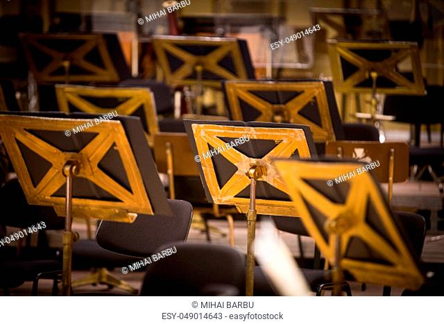 Color image of some orchestra empty seats on a stage