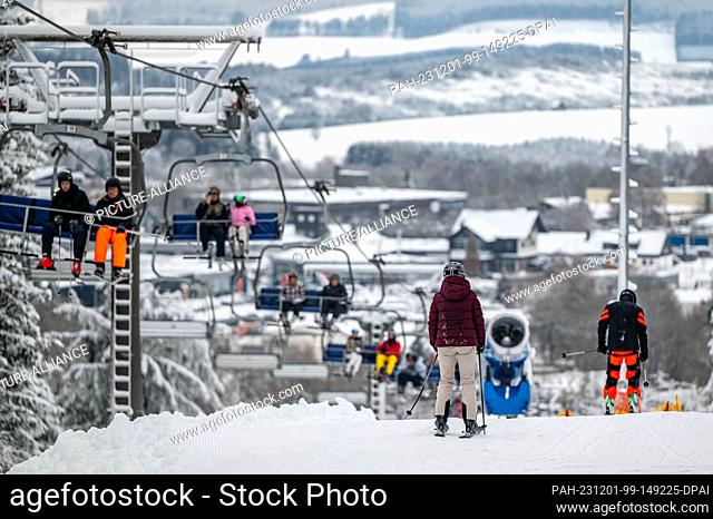 01 December 2023, North Rhine-Westphalia, Winterberg: Leisure sports enthusiasts sit in a chairlift. The winter sports season begins in the ski resorts around...