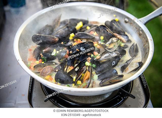 Mussels being cooked up in a skillet