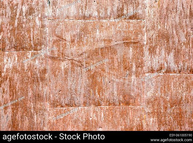 Rusty and corroded metal surface. Grungy texture and background. Tiled and riveted