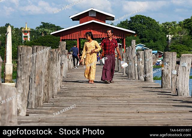 MYANMAR, MANDALAY - OCTOBER 25, 2023: Tourists are seen on the U Bein Bridge spanning Lake Taungthaman. The 1.2-kilometre bridge is believed to be the world's...