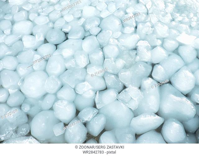 Lumps of snow and ice frazil on the surface of the freezing river water in early winter