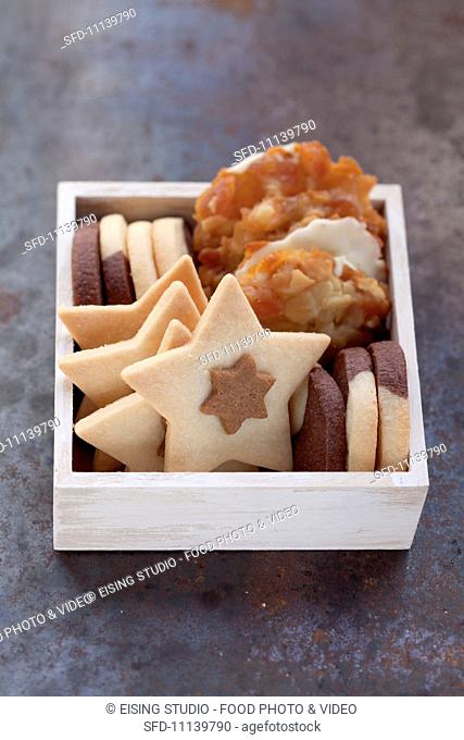 Various biscuits stack upright in a wooden box