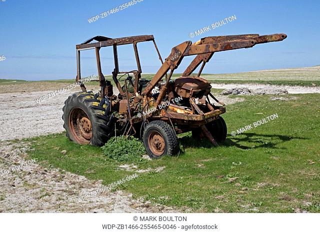 Rusty old tractor in machair Balranald Nature Reserve North Uist Outer Hebrides Scotland