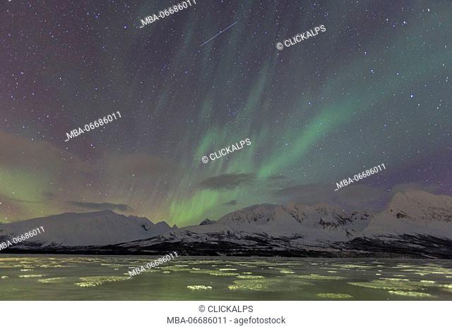 Northern Lights on the icy landscape of Svensby Lyngen Alps Tromsø Lapland Norway Europe